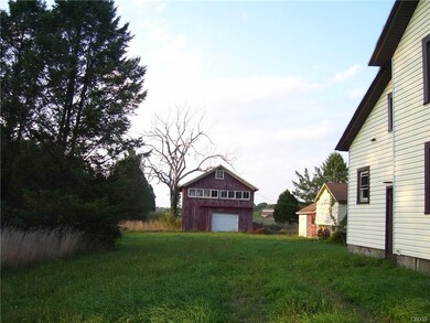 Side of house and barn/garage with entry to worksh