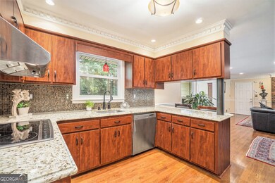 The Kitchen is the Heart of the Home, featuring Rich Stained Cabinets, Granite Countertops, Stainless Steel Appliances, and a Seamless Flow into the Family and Dining Rooms