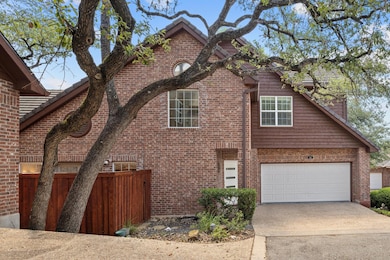 View of front of home with concrete driveway, bri