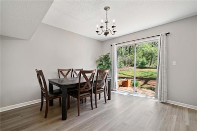 Dining room is located between the kitchen and back patio. This area is quite large, as this is a six person table.