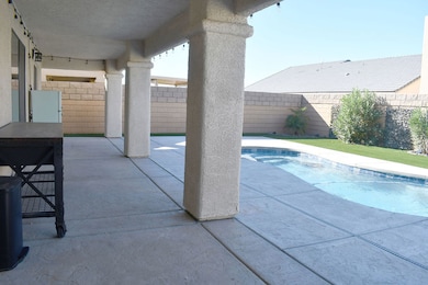 View of swimming pool featuring a fenced backyard and a patio