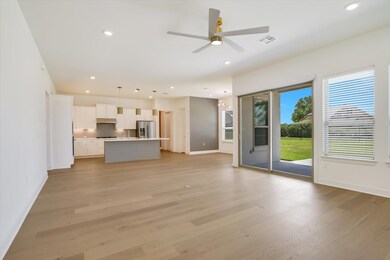 Unfurnished living room featuring baseboards, lig