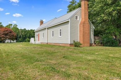View of property exterior featuring a chimney, a y