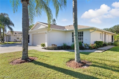 Ranch-style house with stucco siding, driveway, a garage, and a front yard