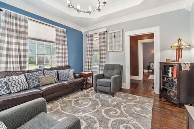Living room featuring a notable chandelier, crown 