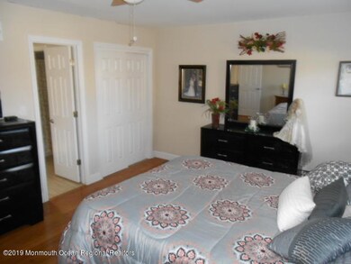 large master bedroom with wood floors