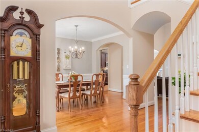 Beautiful staircase when entering the home with updated wood flooring.