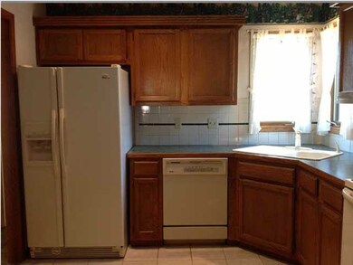 Kitchen with corner sink and window.