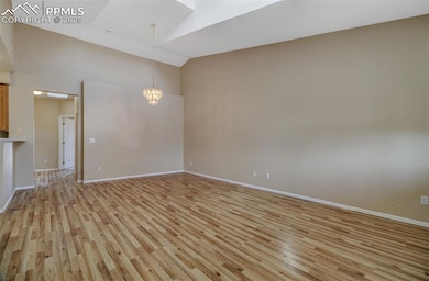Welcoming Great Room with vaulted ceilings, brand new wood laminate flooring and fresh paint