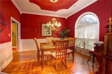 Formal Dining Room with crown molding, arched window for natural sunlight, wainscoting, the detail to the ceiling!