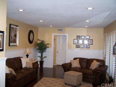 Living room with indirect lighting, wood flooring,