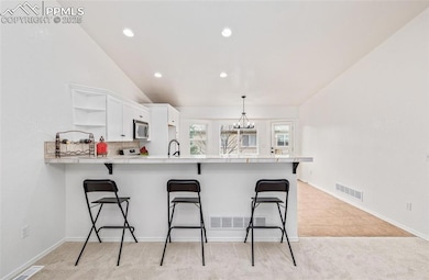 Kitchen featuring a breakfast bar, kitchen peninsu