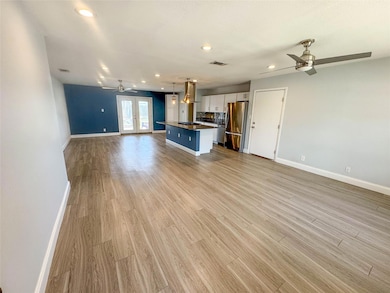 Unfurnished living room featuring a ceiling fan, 