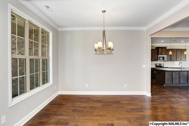 A shadow box chair rail and decorative moldings have been added to the dining and entrance.