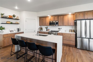Kitchen featuring a kitchen bar, stainless steel a