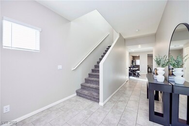 Stairs with tile patterned flooring and baseboards