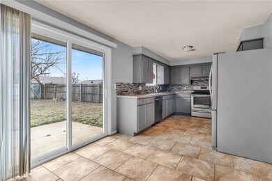 Kitchen with stainless steel appliances, backsplas