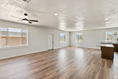Unfurnished living room featuring plenty of natural light, light wood-style floors, recessed lighting, and a ceiling fan