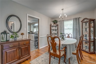 Dining area featuring a chandelier and light wood-