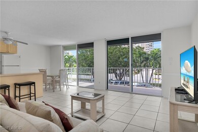Living area with floor to ceiling windows, light tile patterned floors, a textured ceiling, and a ceiling fan