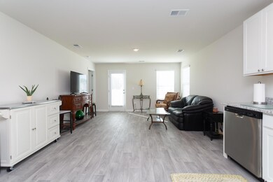 Living room with light hardwood / wood-style flooring