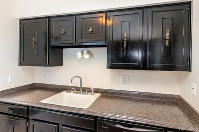 Kitchen with dark countertops and dishwasher