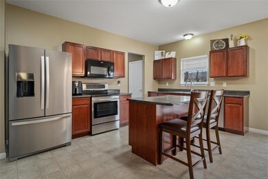 Kitchen has central island w/ breakfast bar and st
