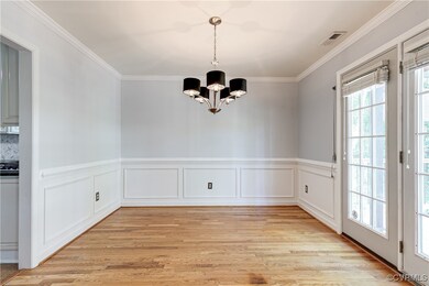 Dining Room with chair rail, wainscotting and door
