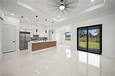 Kitchen with built in refrigerator, a ceiling fan,