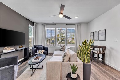 Living area featuring ceiling fan, wood finished f
