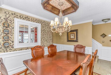 Tiled dining area featuring a textured ceiling, cr