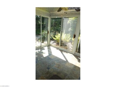 A pretty Sun Porch has sliding glass doors to the 