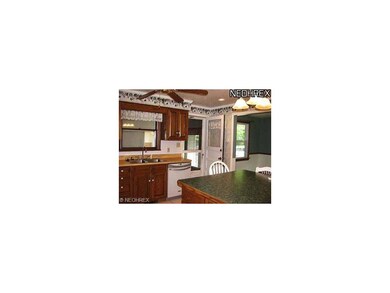 Kitchen with ceramic floor, oak cabinets, work isl