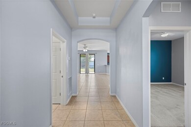Hallway with arched walkways, light tile patterned