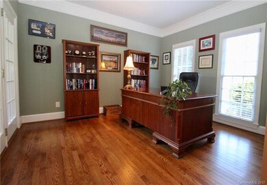 Home office with great natural light sits off foye