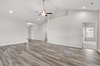 Empty room featuring carpet flooring, high vaulted