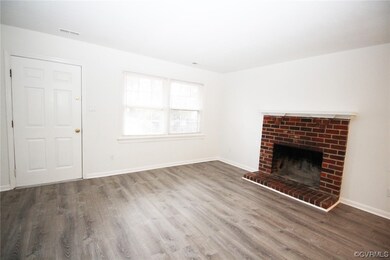 Unfurnished living room featuring a fireplace and hardwood / wood-style flooring