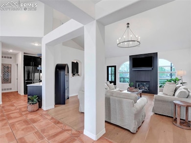Living room with high vaulted ceiling, a fireplace
