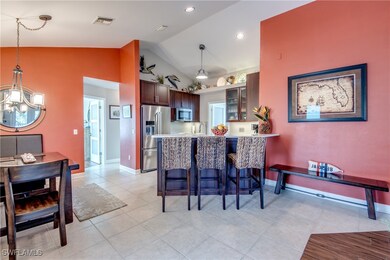 Kitchen featuring lofted ceiling, appliances with