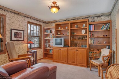 Main floor library featuring custom cabinets with 