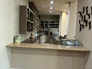 Kitchen with stainless steel refrigerator with ice