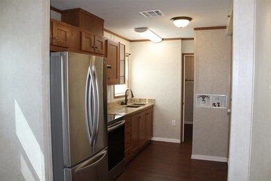 Kitchen area has washer dryer connections.
