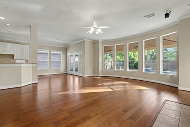 Gleaming floors, high ceilings and crown molding in the family room leading into the breakfast area and kitchen.