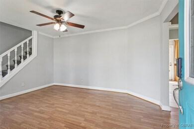Empty room featuring crown molding, ceiling fan, a