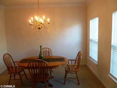 Dining Room - The dining room is well connected to the kitchen for ease in entertaining. Plantation blinds, chandelier and crown moulding put the finishing touches on this spacious room.