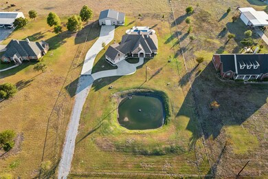 Elegant home on 1.75 manicured acres with pond, shop, additional living quarters, pool, spa and outdoor living area.