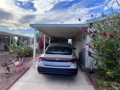 View of parking featuring a carport