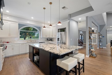 Kitchen with stainless steel appliances, light wo