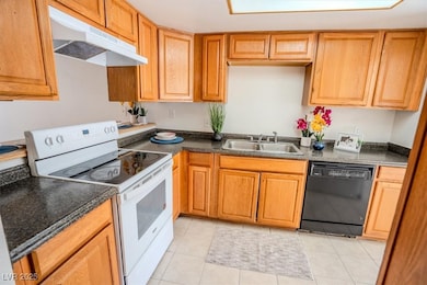 Kitchen with white electric range, under cabinet r