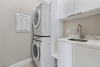 Laundry area with a sink, cabinet space, baseboard